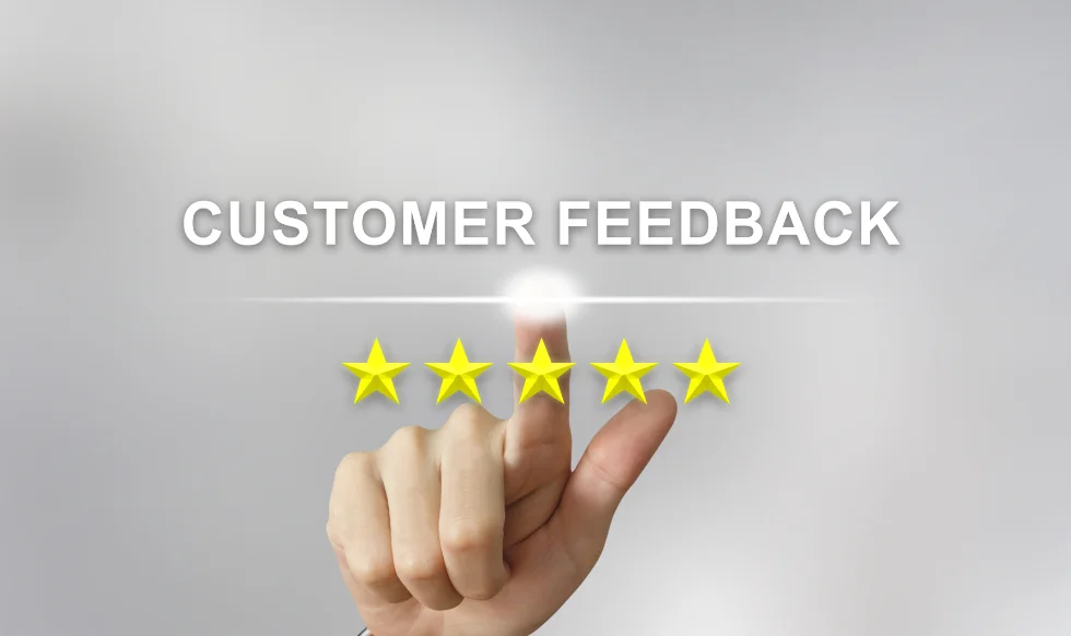 A hand pointing to a glowing five-star rating with the words "Customer Feedback" above it, symbolizing positive client reviews and satisfaction.
